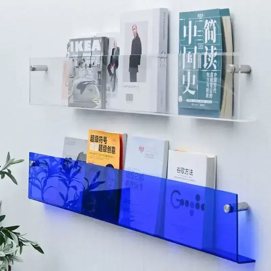 Wall-mounted clear and blue acrylic storage shelves with books and magazines, modern home decor.