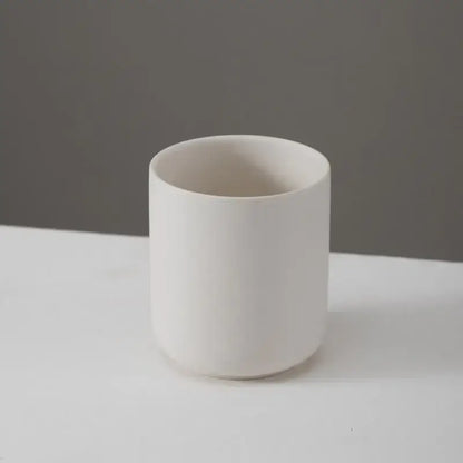 Bougeoir en céramique blanc avec finition mate, parfait pour bougies ou plantes, apportant une touche d'élégance à votre intérieur.