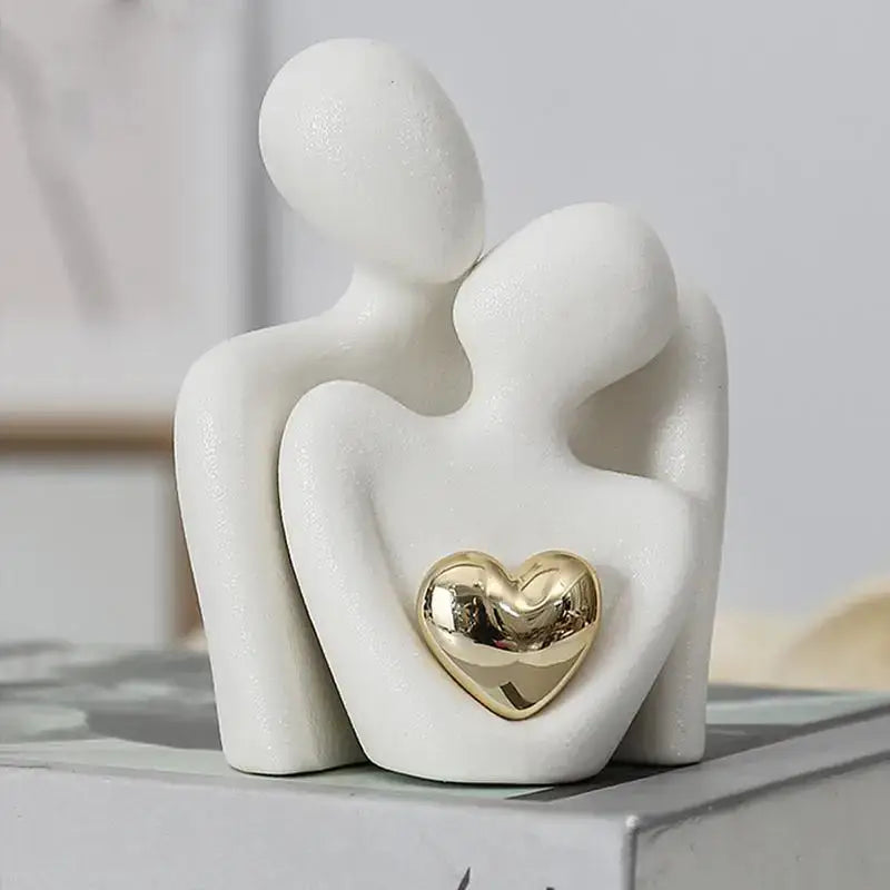 Ceramic couple hugging figurine with gold heart, modern artistic décor symbolizing love and unity