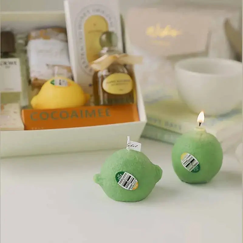 Green and yellow lemon-shaped scented candles on a table, offering a fresh citrus aroma, perfect for home decor and relaxation.