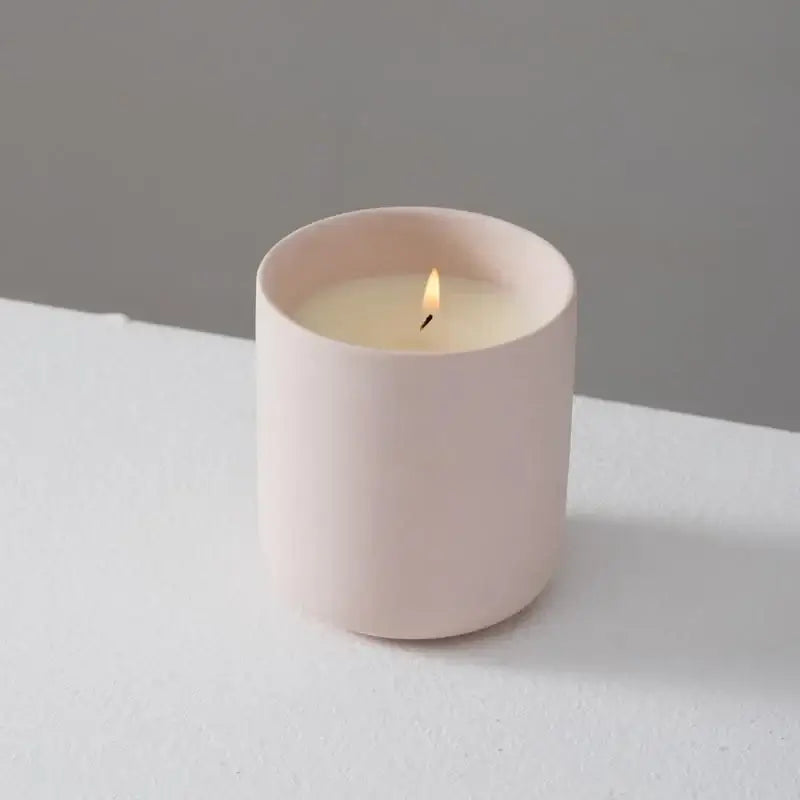 Ceramic candle holder with matte finish in light pink color, perfect for adding a touch of elegance to any room.