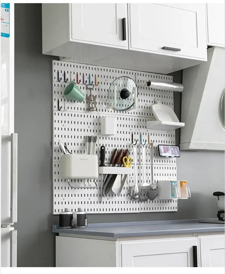 Wall-mounted kitchen storage organizer with various accessories including hooks, shelves, and containers for efficient space management