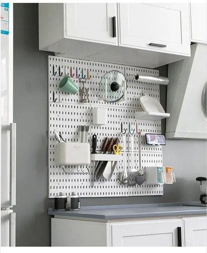 Wall-mounted kitchen storage organizer with various accessories including hooks, shelves, and containers for efficient space management