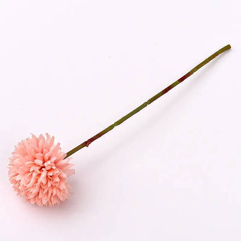 Single pink silk chrysanthemum flower with green stem on white background