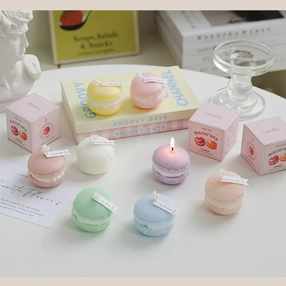 Colorful macaron-shaped scented candles displayed on books and a table, creating a relaxing and elegant ambiance.