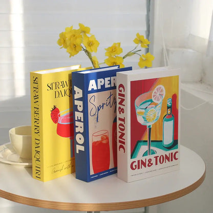 Decorative faux books with bohemian chic design for sophisticated interior decoration on a table with yellow flowers.