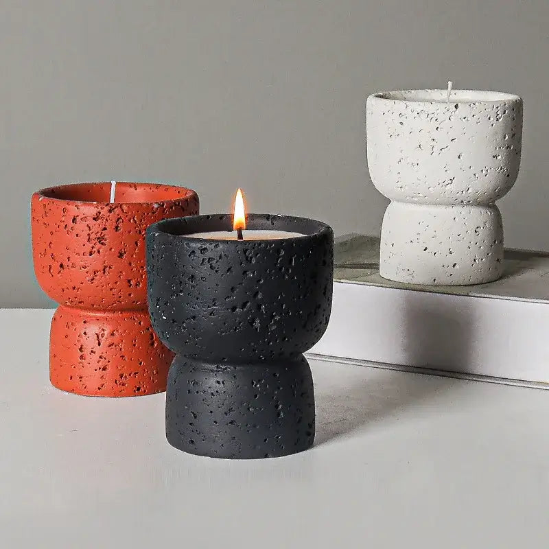 Minimalist cement candle holders in black, white, and terracotta colors, enhancing modern home décor with an elegant touch.