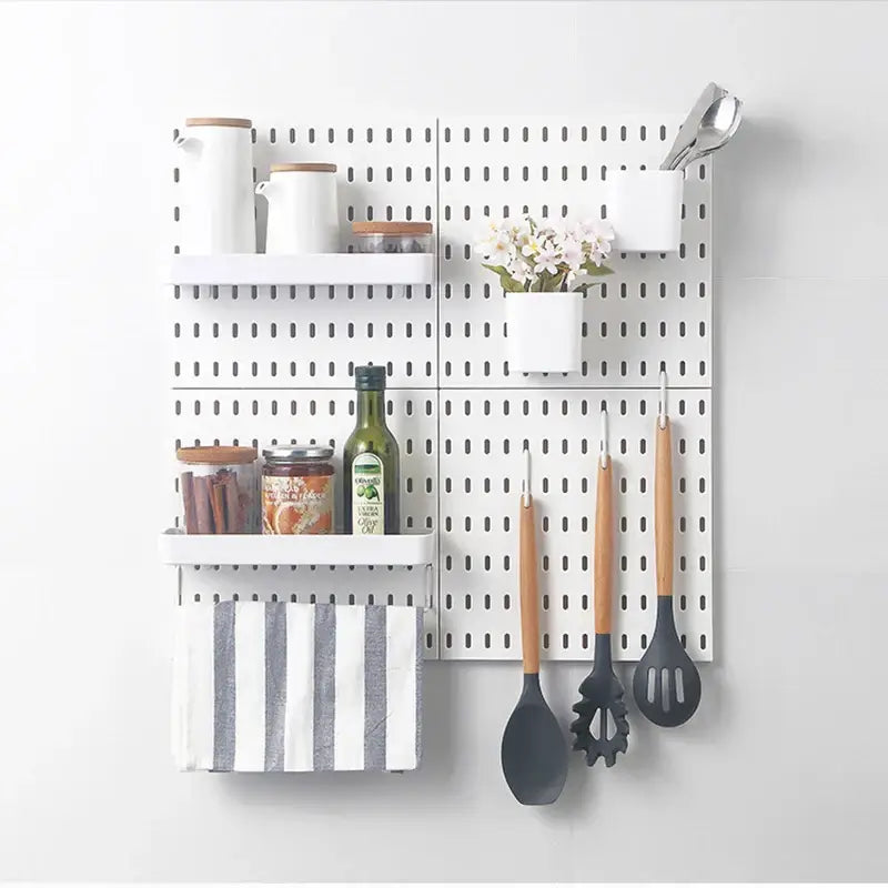 Wall-mounted kitchen organizer with shelves, hooks, and accessories, featuring utensils and storage jars, ideal for enhancing space with style