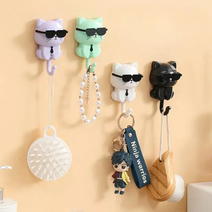 Colorful cat-shaped accessory hooks on wall, holding various items like keychains and brushes. Available in purple, green, white, and black.