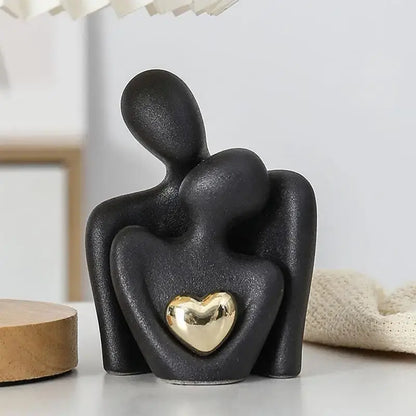 Modern black ceramic couple hugging figurine with gold heart, a symbol of love and unity, perfect for romantic home décor.