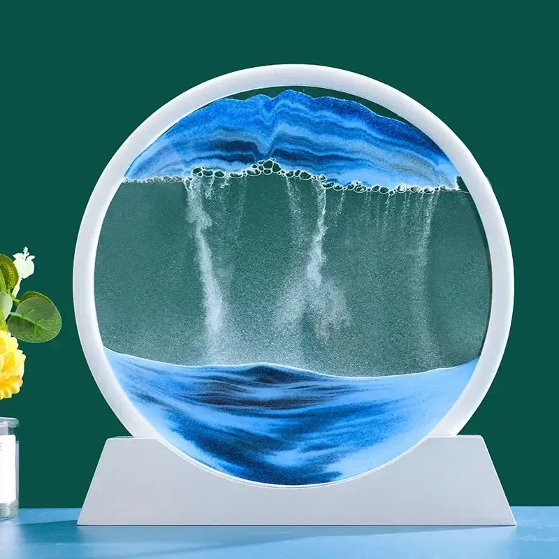 Sablier décoratif circulaire en verre avec motif de sable bleu et blanc sur fond vert