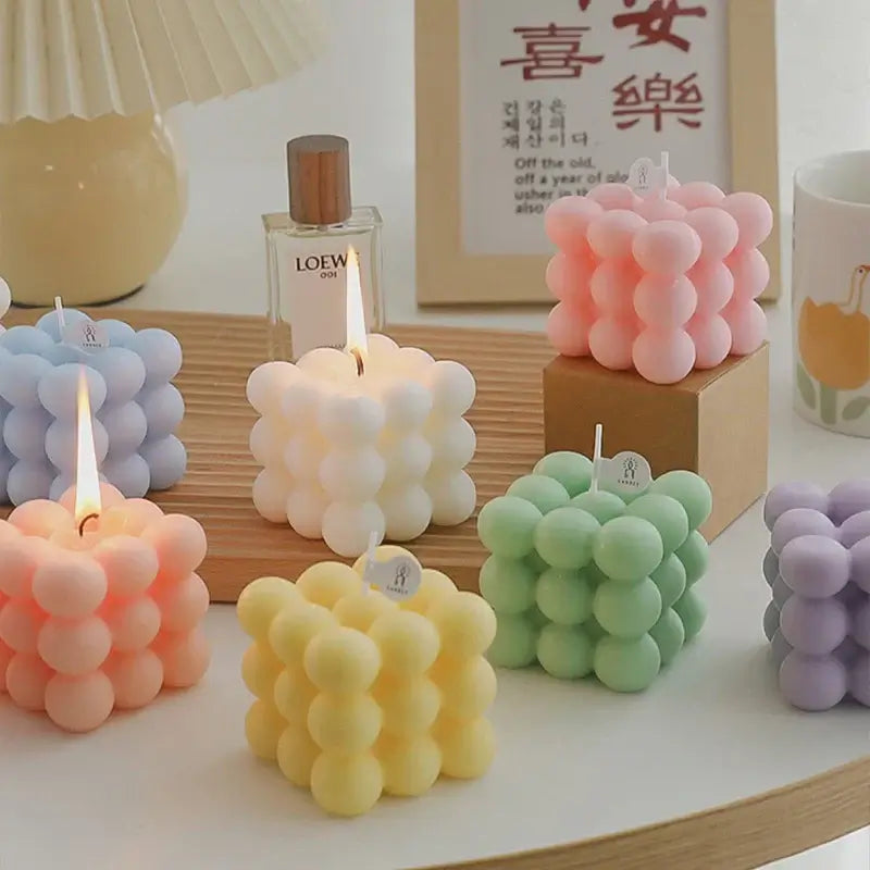 Handcrafted scented bubble candles in various pastel colors made from natural soy wax for a clean burn, displayed on a table.