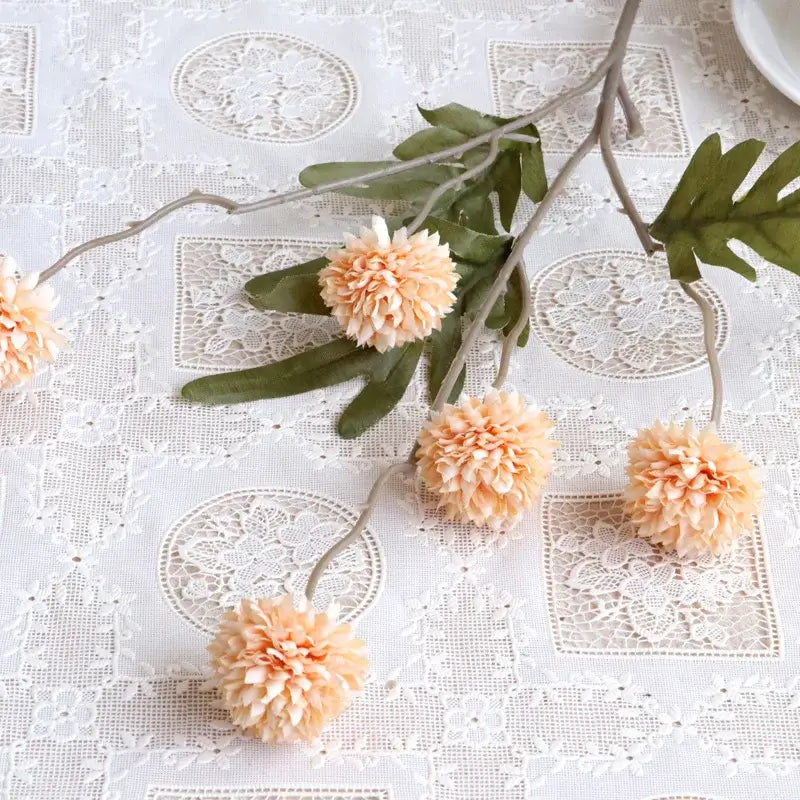 Artificial dandelion bouquet for wedding and home decor on a lace tablecloth