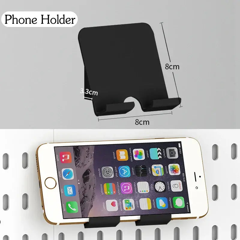 Wall-mounted black phone holder with dimensions, holding a smartphone in a kitchen organizer setup