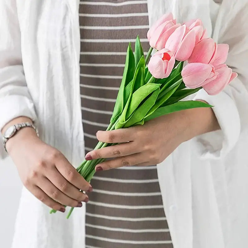 Woman holding a bouquet of pink silk tulips, perfect for elegant home decoration and special occasions like weddings and parties.