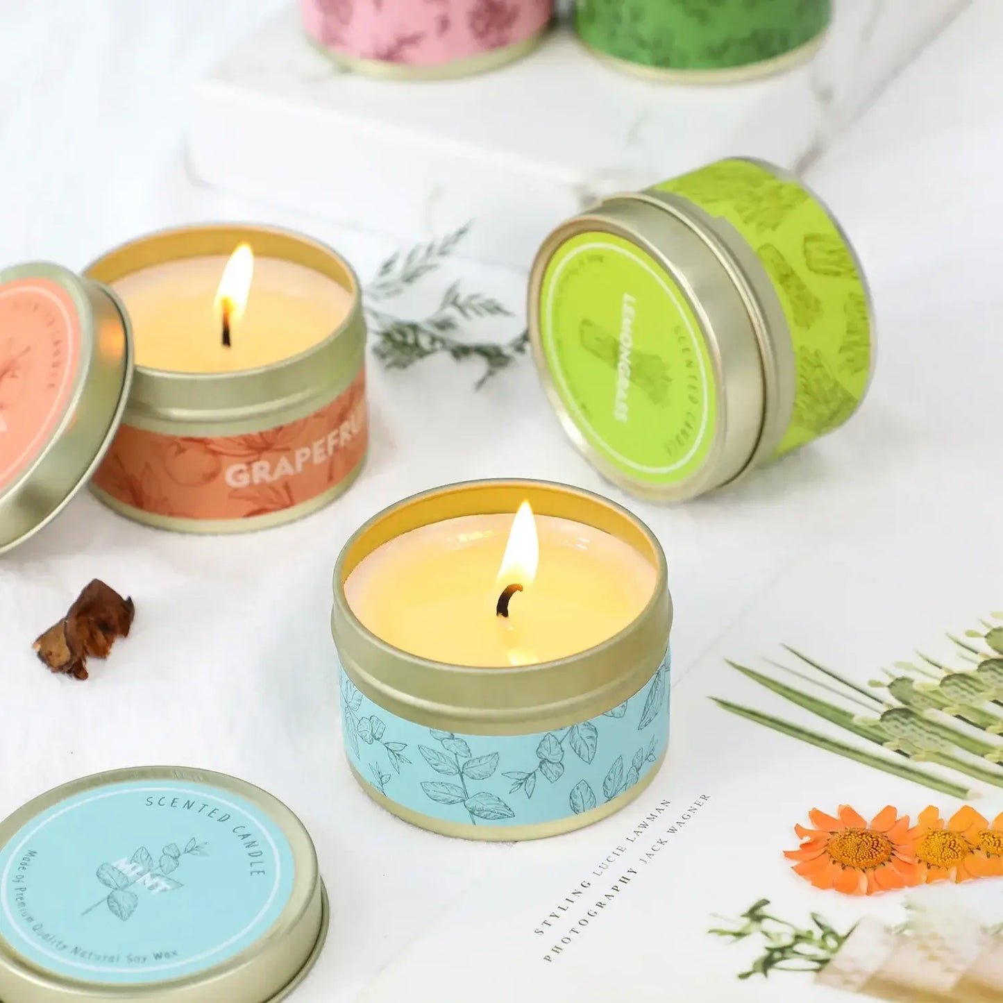 Scented soy candles in colorful tins with floral designs, perfect for home decor and relaxation.