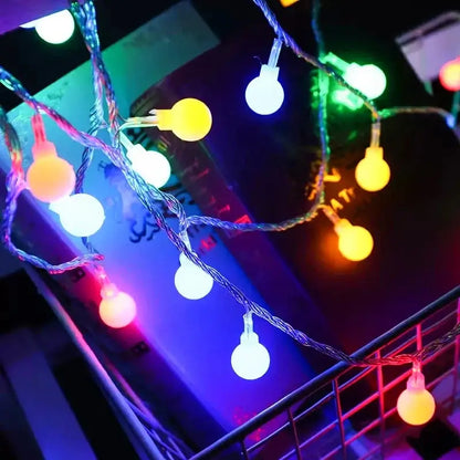 Multicolored LED ball string lights illuminating a dark space, perfect for parties, celebrations, and home decoration.