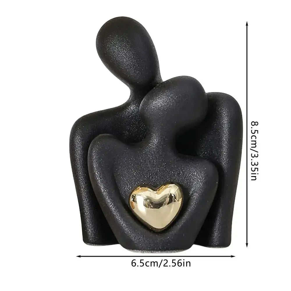 Decorative ceramic couple figurine with a gold heart, symbolizing love and unity, dimensions 8.5cm height and 6.5cm width.