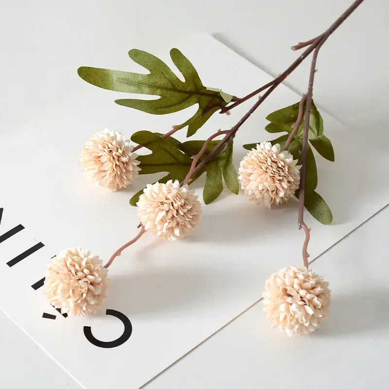 Branch of artificial dandelion flowers for wedding, home, and Christmas decoration on a white background.